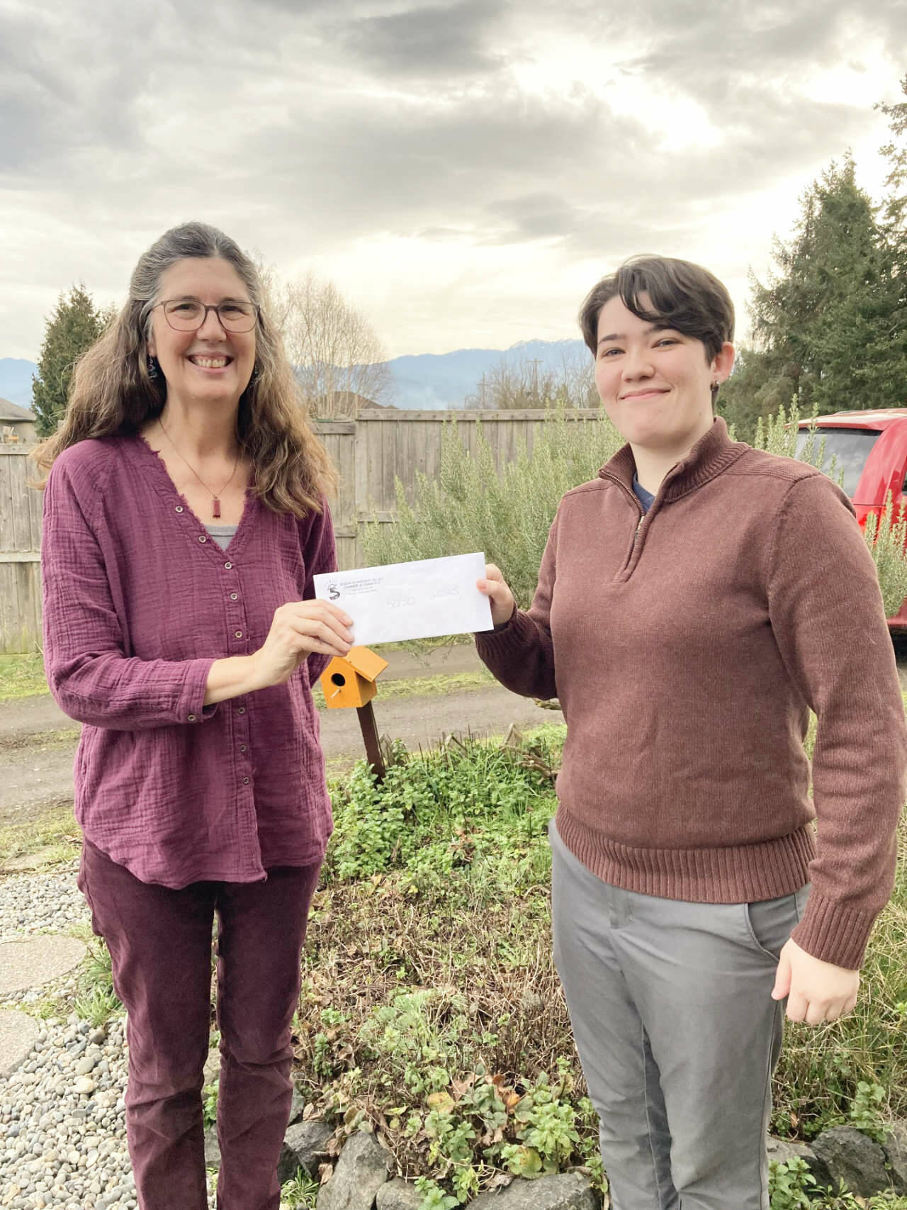 Photo courtesy Sequim-Dungeness Valley Chamber of Commerce
Cherie Melton happily accepts a check for one-half of the $1,340 raised by the Sequim-Dungeness Valley Chamber of Commerce through its annual 50-50 raffle. Throughout the year, members can purchase raffle tickets online or at chamber events for the December drawing. Half the money goes to the chambers Howard Wood Scholarship. Melton is presented the check by chamber Membership Coordinator Kendall Melton - her daughter.