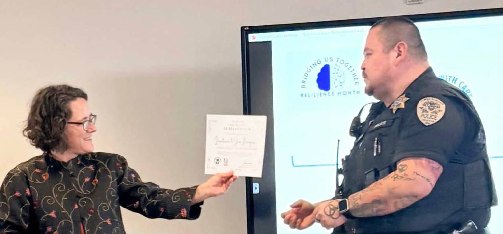 Photo courtesy Clallam Resilience Project 
Lieutenant Jim Thompson of the Lower Elwha Police Department accepts his Certificate of Recognition.