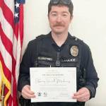Photo courtesy Clallam Resilience Project 
Officer Daniel Martinez of the Sequim Police Department with his Certificate of Recognition.