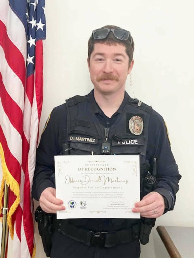 Photo courtesy Clallam Resilience Project 
Officer Daniel Martinez of the Sequim Police Department with his Certificate of Recognition.