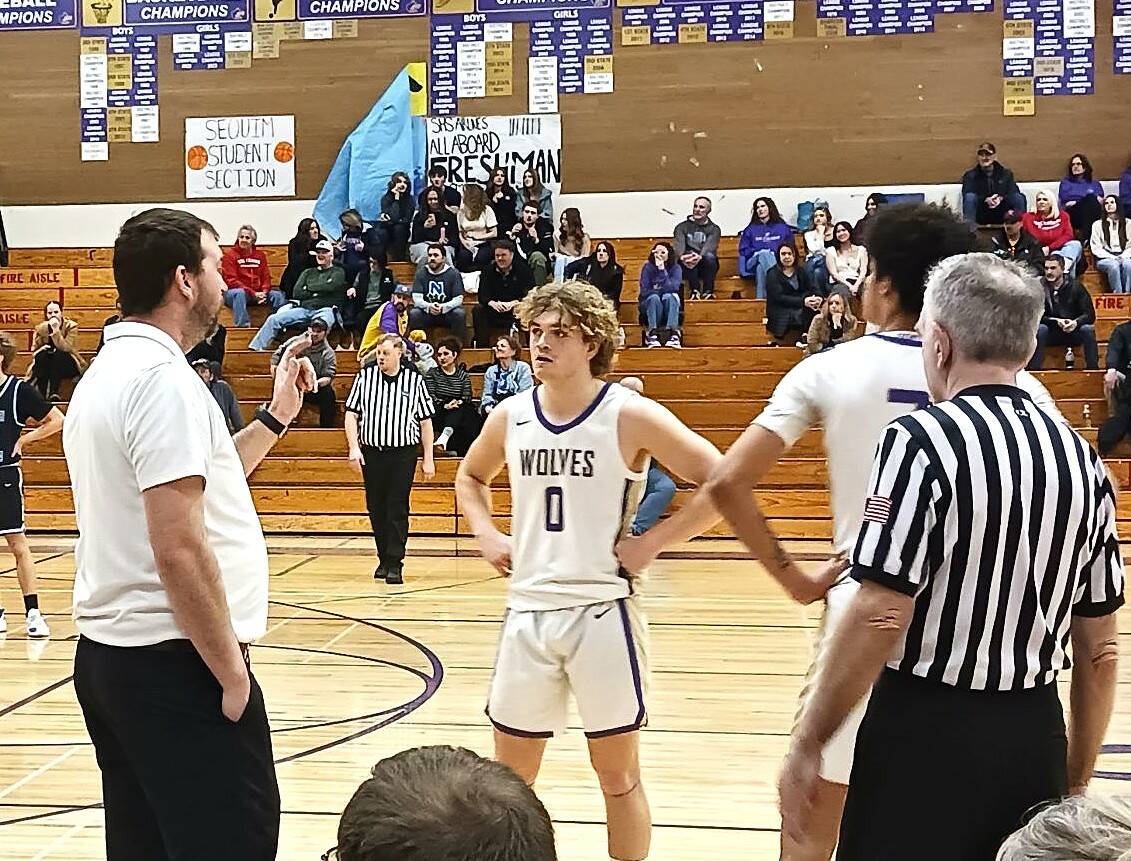 Olympic Peninsula News Group photo by Pierre LaBossiere/
Sequim boys basketball coach Craig Brooks talks to Zeke Schmadeke (0) and Solomon Sheppard during the game Saturday, Feb. 14 in Sequim. The Wolves went on to defeat North Mason 69-42 in the district game.