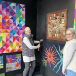 Photo by Leslie Dickinson 
Debra Olson, left, and Sue Gale install Wild Things in the Peninsula Fiber Artists walk-by exhibit at 675 Tyler St., open through March.