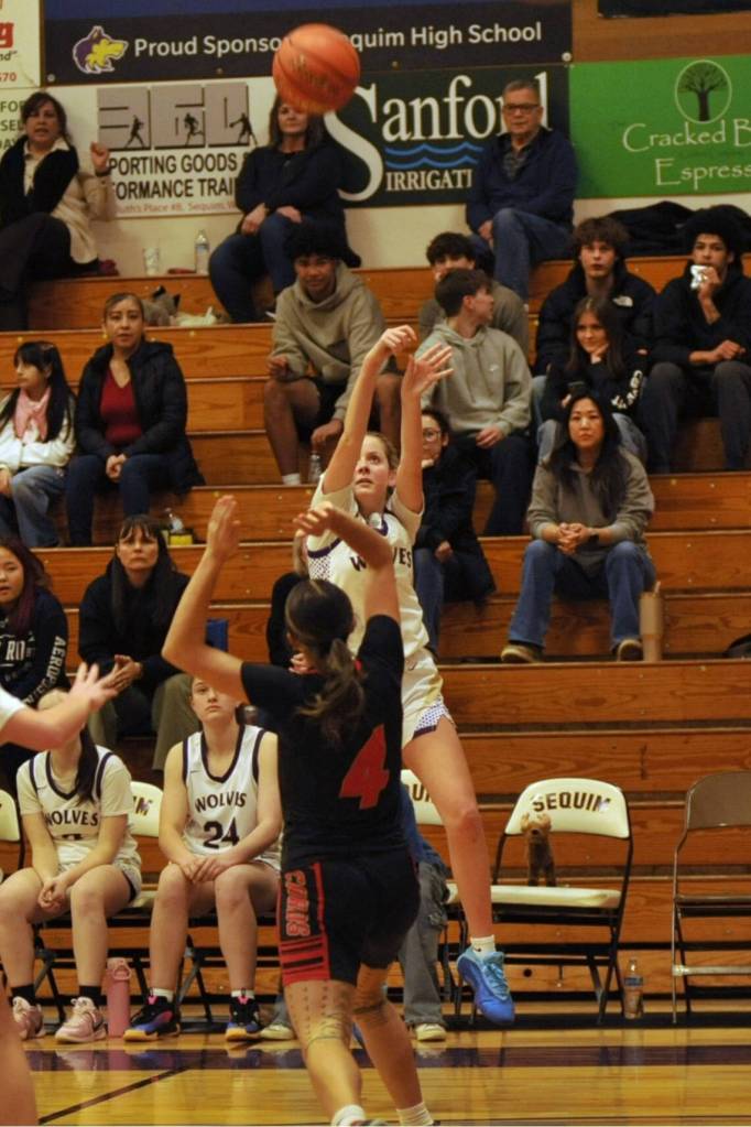 Sequim Gazette photo by Matthew Nash/ Sequims Kaiya Robinson goes up and sinks one of her three 3-pointers against Orting.