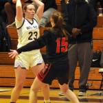 Sequim Gazette photo by Matthew Nash/ Rilynn Whitehead looks for a teammate over Ortings Ryann Polly with Sequim coach Joclin Julmist in the background.
