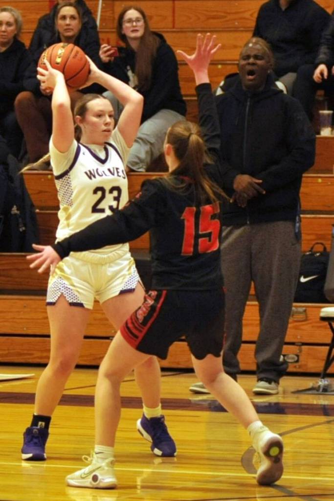 Sequim Gazette photo by Matthew Nash/ Rilynn Whitehead looks for a teammate over Ortings Ryann Polly with Sequim coach Joclin Julmist in the background.