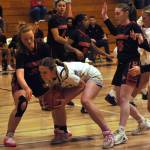 Sequim Gazette photo by Matthew Nash/ Hailey Wagner grabs a rebound for the Wolves over three Orting players.