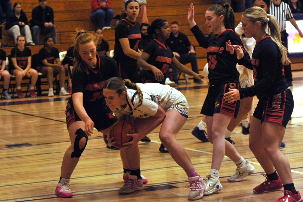 Sequim Gazette photo by Matthew Nash/ Hailey Wagner grabs a rebound for the Wolves over three Orting players.