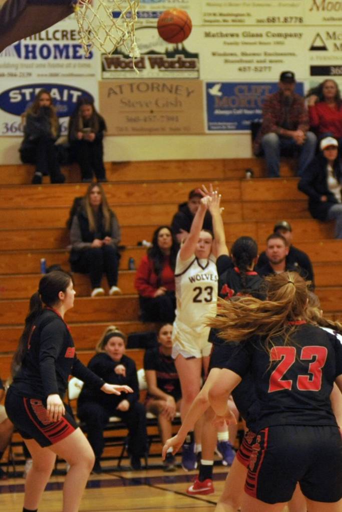 Sequim Gazette photo by Matthew Nash/ Rilynn Whitehead goes up for a 3-pointer over Orting defenders.