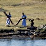 Photo courtesy Steve and Mirja Wilson/ Egyptian farmers hook up massive hoses to diesel pumps to spread water far from the shore of the Nile River.