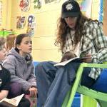 Sequim Gazette photo by Matthew Nash/
Sequim high schooler Billy Struve reads Animorphs to third graders Calvin Crews and Vera Eksteen on Monday morning for Read Across America Day in Sequim.