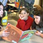 Sequim Gazette photo by Matthew Nash/ Eighth grader Josephine Bower reads to second graders Layla Cheek and Amelia Sturdivant a copy of The Little Mouse, the Red Ripe Strawberry and the Big Hungry Bear.