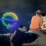 Sequim Gazette photo by Matthew Nash/ A family enjoys the Illuminated Drone Show on March 7 from the parking lot of Greywolf Veterinary Hospital, just south of Carrie Blake Community Park.