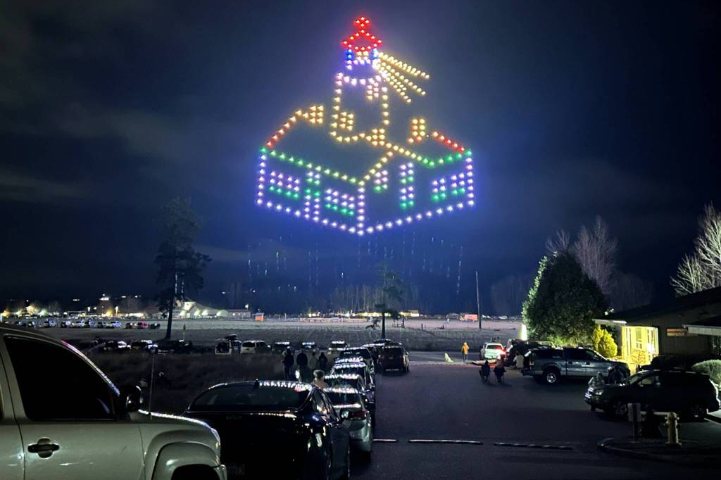 Sequim Gazette photo by Matthew Nash/ A lighthouse, a crab, and a Sasquatch were some of the many items depicted hovering over Carrie Blake Community Park during the Sequim Sunshine Festival drone show.