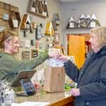 Sequim Gazette photo by Monica Berkseth 
Lacy Thompson, new owner of Full Moon Candle Co., rings up longtime customer Vicki Walp, who came into the store to buy chocolate-scented candles after hearing that the scent was being discontinued.