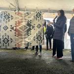 Sequim Gazette photo by Matthew Nash
New Sequim Food Bank Executive Director Jen Colmore, second from right, introduces a blanket called Agate Beach donated by the Jamestown SKlallam Tribe for outgoing Executive Director Andra Smith, on right. Colmore read a note from food bank board director Loni Greninger that said the blanket symbolized the process of agates becoming beautiful rocks from pressure and friction. Food bank staff wrapped Smith in the blanket as a thank you as she has taken a new job as the Washington Food Coalitions executive director.