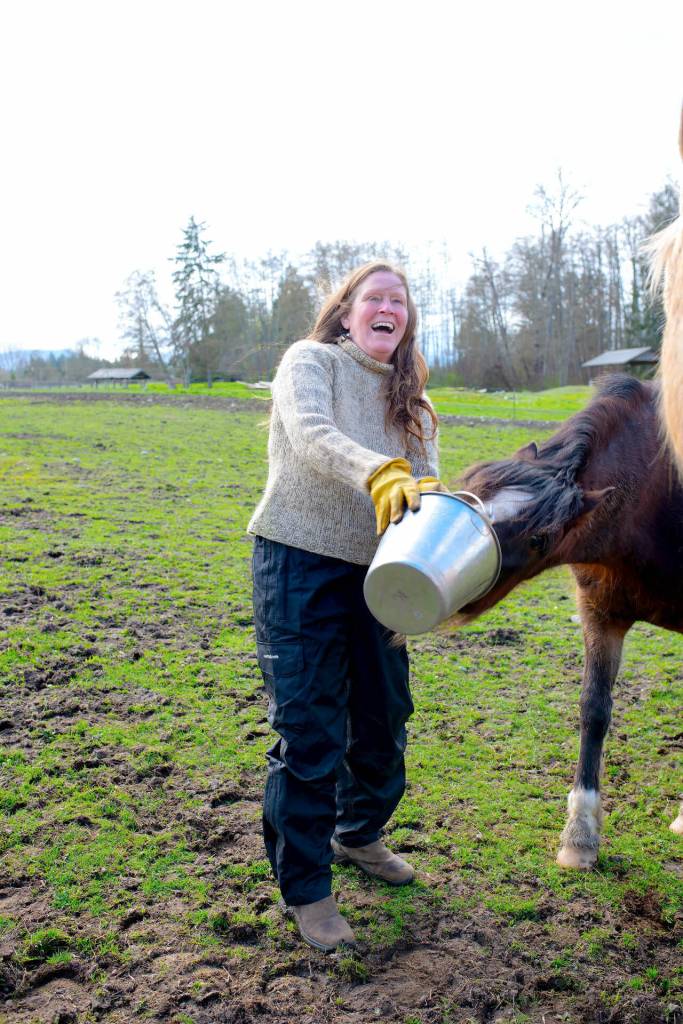 Sequim Gazette photo by Monica Berkseth
Ellis laughs as her Welsh B horse Cricket steals apples from her bucket. Ellis is able to enjoy and participate in life more thanks to peritoneal dialysis and a subsequent kidney transplant.