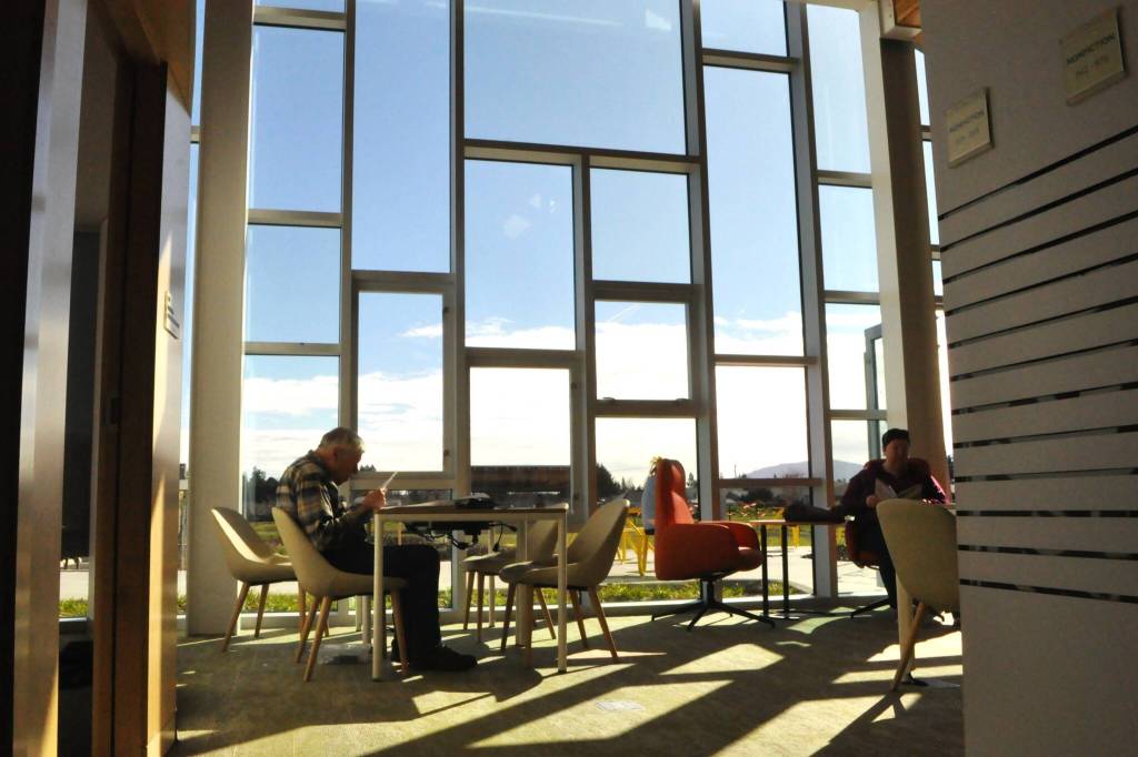Sequim Gazette photo by Matthew Nash/ The east wall of the Sequim Library features a large windowed wall with a view to the outside stage and back seating area.