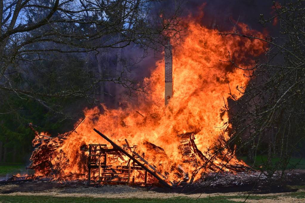 Photo by Jay Cline/ The two-story Gerhardt Park home was allowed to burn after training sessions all day on March 21.