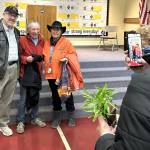 Sequim Gazette photo by Matthew Nash/ Ciscoe Morris, center, takes a photo with Sir Andrew Woodson with KSQM radio and Beberly Wamber after Morris lecture on March 22. Wamber said she watched Morris for years on TV and happened to run into him at Sunny Farms the day before and he invited her to his lecture during the Soroptimist Gala Garden Show.