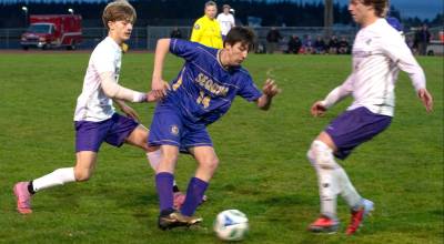 Photos by Emily Matthiessen 
Sequims Tristen Weston-Webb looks to move past North Kitsap defenders on March 19. The Wolves won their first game of the season 4-1 in Kingston and lost a close match 1-0 in Sequim against the Vikings.
