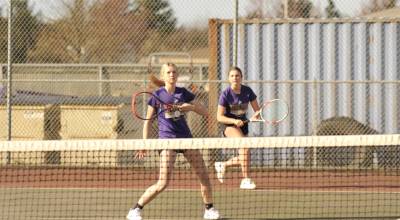 Sequim Gazette photo by Matthew Nash
Lily Sparks returns a hit with teammate Abby Brown behind her during a match on March 26.