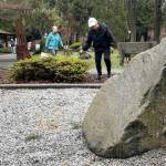 Volunteers Jennie Petit and Angie Terry clean up different areas of the Friendship Garden within Carrie Blake Community Park. They host an open house from noon-3 p.m. Saturday, April 4 with various art activities, tours, and more.