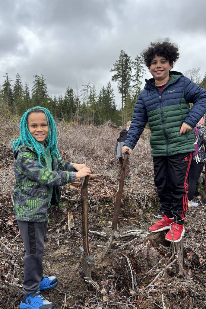 Jazzy Haabala and Ezekiel Hicks search for great spots to plant trees on March 25.