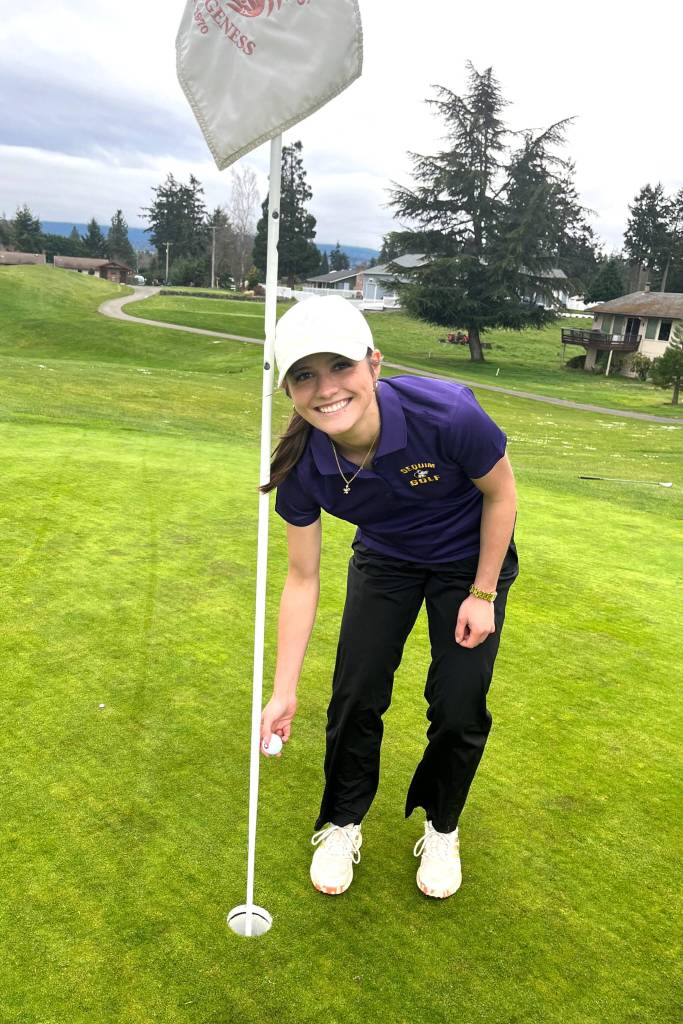Photo courtesy The Cedars at Dungeness
Raimey Brewer pulls the ball from the cup after hitting her first hole-in-one.