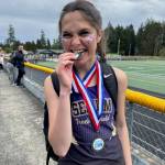 Photo courtesy Kirsti Turella
In a ceremonial chomp, Clare Turella celebrates winning the high jump at the Olympic League meet in May 2025.