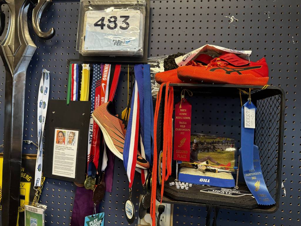 Photo courtesy Kirsti Turella/
High jump has become a central part of Clare Turellas life since middle school, including this eighth grade project that featured a homemade high jump pit. Now its become a centerpiece in a celebratory shrine with her medals, ribbons, competition numbers, and spikes from past competitions. Theres even a mini-version of Clare she made for the school project.
