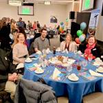 Guests and speakers seated at the speakers table are, from left, Ron Coffman, Sue Coffman (speaker), Nicholas Saul, Hailee Huggans (speaker), Vice President of Social Impact Anne Dean, and personal trainer Lisa Fox.