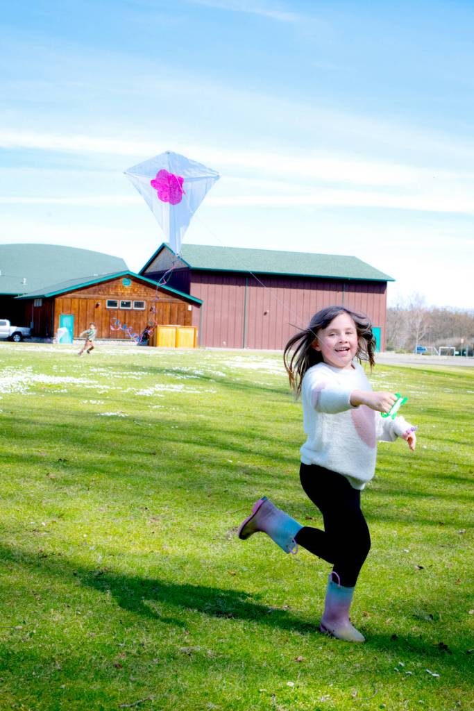 Claire Packer, 6, of Sequim, flies the kite she made at the Friendship Garden open house event at Carrie Blake Community Park.