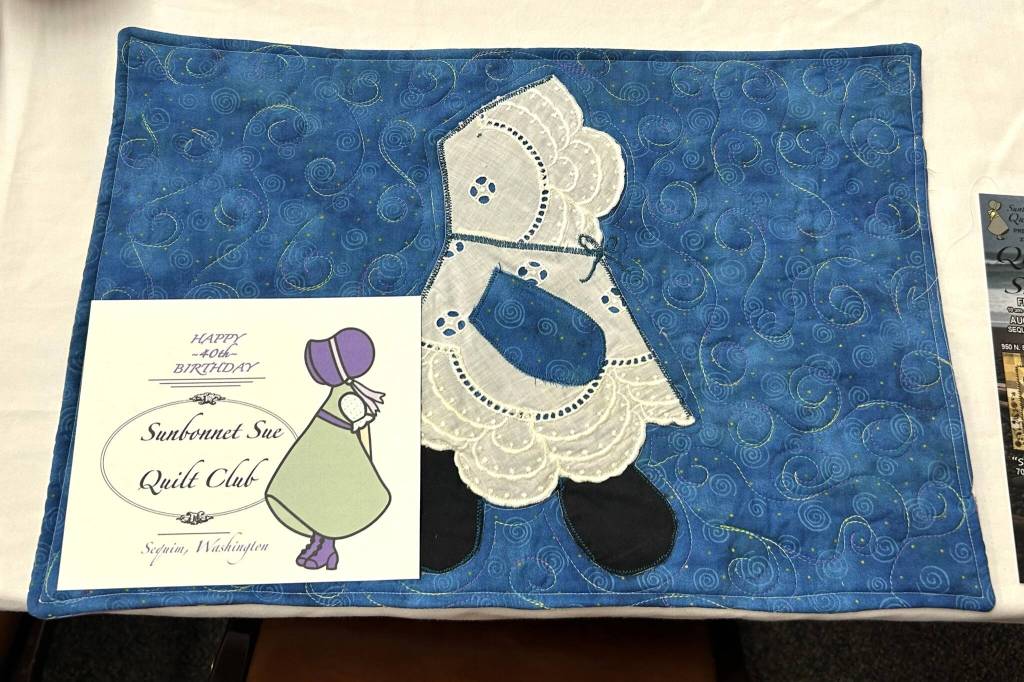 Sequim Gazette photo by Matthew Nash/ 
Each seat had a handmade place mat to celebrate the Sunbonnet Sue Quilt Club's 40th anniversary.
