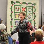 Sequim Gazette photos by Matthew Nash
Norma Herbold, co-organizer of the Sunbonnet Sue Quilt Clubs 40th anniversary party, shows off her Safeway after 5 coat she made and wore during the partys Wearable Fashion Show on April 8.