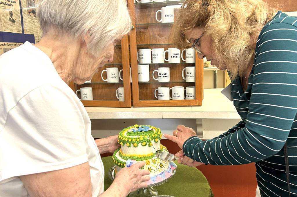 Sequim Gazette photo by Matthew Nash/
The Sunbonnet Sue Quilt Clubs most tenured member Joanne Thoma, left, works with its newest, Stephannie Flynn, who joined two weeks ago, to cut a special cake made by the clubs youngest member, Sage Glover. Flynn said she moved to the area two years ago and wanted to be more active in the community and connected with the club through her neighbor Toni Cline.