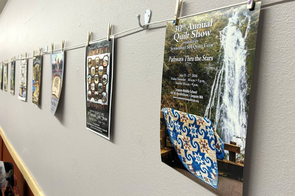 Sequim Gazette photo by Matthew Nash/
Posters from the Sunbonnet Sue Quilt Clubs annual quilt shows were placed on the wall of the Sequim Masonic Lodge during the clubs 40th anniversary.