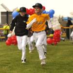 Sequim Gazette photo by Matthew Nash/
Players with Rainshadow Coffee Roasters majors baseball team run out during the Player Parade on April 11 for opening day of Sequim Little Leagues season.