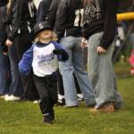Sequim Gazette photo by Matthew Nash/
A Kinder T-ball player with Integrity Pumps & Filtration runs onto Don Knapp Field on April 11 during the Player Parade.