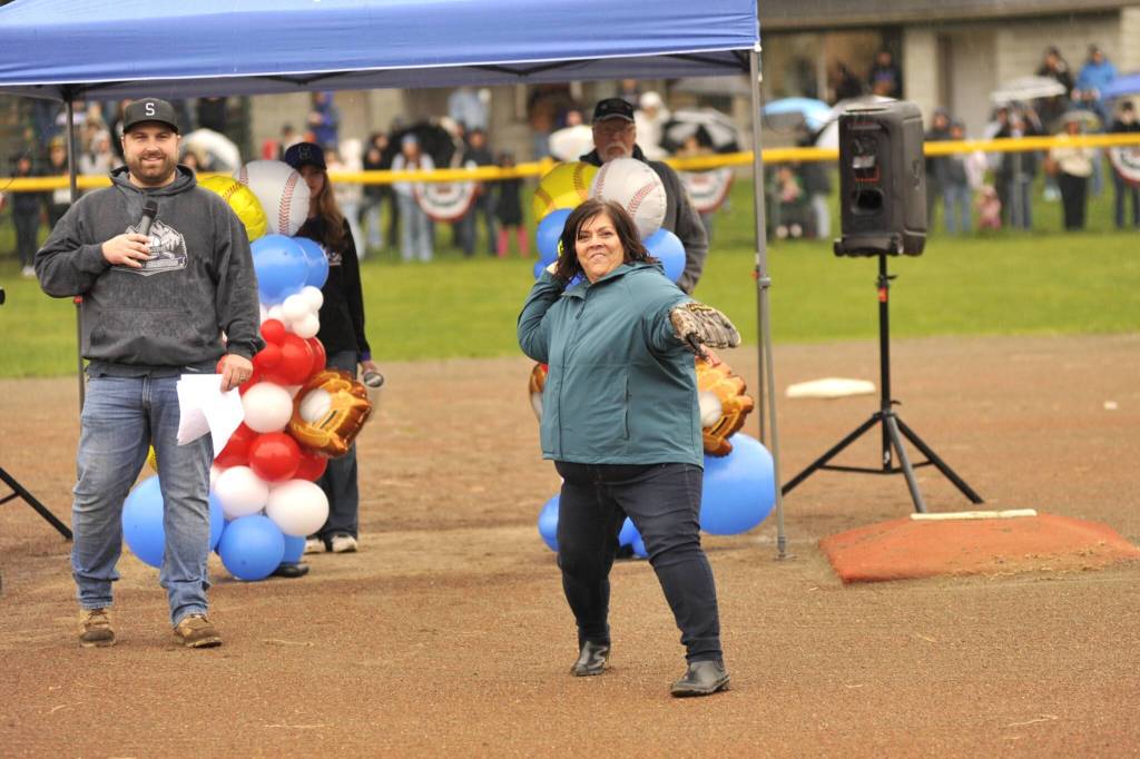 Cathy Murillo Bourm throws out a ceremonial first pitch in honor of her late father Herman Murillo, who has a field named after him for his decades of supporting Sequim Little League.