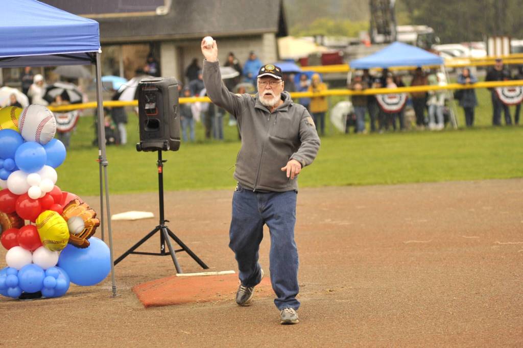 Sequim Gazette photo by Matthew Nash/
Bud Knapp throws out one of two ceremonial first pitches, with his pitch honoring his late brother Don Knapp, who has a field named after him.