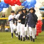 Sequim Gazette photo by Matthew Nash/ Colin Hiday Concretes majors baseball team runs onto the field during the Player Parade.