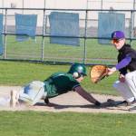 Photo by Emily Mathiessen
Port Angeles Easton Fisher slides into first base as the throw comes to Sequim first baseman William Kuperus on April 9 in Sequim. The Roughriders won.