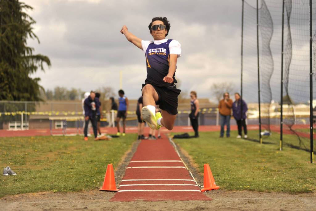 Sequim Gazette photo by Matthew Nash/ Ianson Klinger jumps 14-6 in the long jump on April 15.