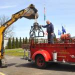 Sequim Gazette photo by Matthew Nash/
Daniel Berneking with Doin Stuff picks up the Lost Mountain School bell with guidance by Tharin Huisman, maintenance supervisor for Clallam County Fire District 3, on Friday, April 17. It was placed in front of Sequim Museum & Arts. The bell had been atop the Lost Mountain Fire Station from 1980-2024.