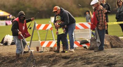 Sequim Gazette photos by Matthew Nash
Colin Banitch helps his son Finn, 5, reel in a trout during Kids Fishing Day with help from volunteers with the North Olympic Peninsula Chapter of Puget Sound Anglers.