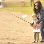 Sequim Gazette photo by Matthew Nash/
Cole Lotzgesell, 2, fishes with his mom Allison on Kids Fishing Day. It was Coles first time fishing, and family members said he liked holding the pole.