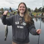 Annabelle Hollek, 14, of Seattle holds up a trout she caught at Kids Fishing Day on April 18. She and her family were visiting her grandpa Larry Belmont who is a volunteer with the North Olympic Peninsula Chapter of Puget Sound Anglers.