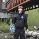 Mason Rapelje, an Interact Club member, holds up a jug of water during the Walk for Water event on April 18 at the Dungeness River Railroad Bridge.