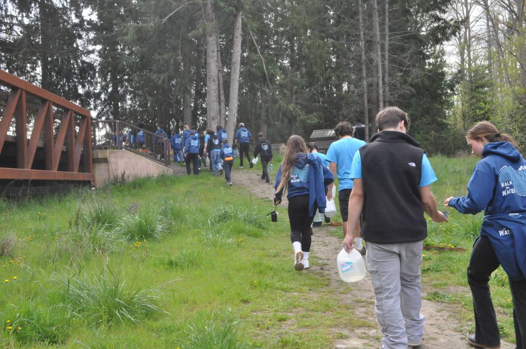 Sequim Gazette photo by Matthew Nash/ Students begin their journey from the Dungeness River back to Sequim Middle School with jugs and buckets filled with water for Sequim High Schools Interact Clubs annual Walk for Water fundraiser.