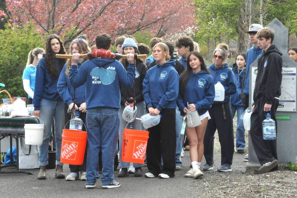 Sequim Gazette photo by Matthew Nash/ Sequim High School Interact Club members get ready to begin their journey from Sequim Middle School to the Dungeness River to carry cartons and buckets filled with water for the clubs annual Walk for Water fundraiser.